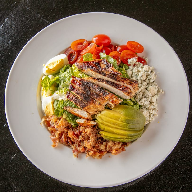 Mayworth's Public House Cobb salad with grilled chicken, avocado, bacon, egg, tomatoes, and blue cheese.